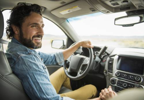 Smiling driver inside a car