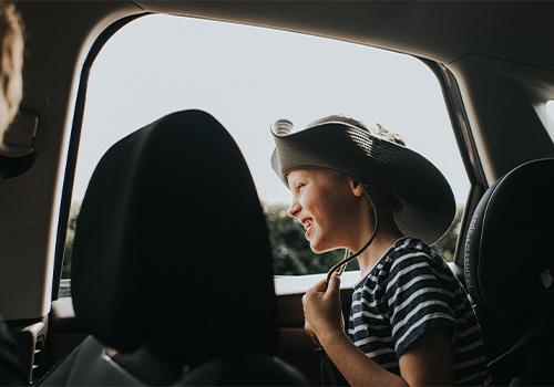 Child next to open car window