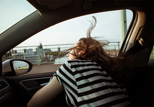 Woman leaning out of car window