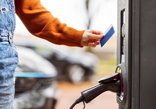 Woman paying with electric vehicle charging card