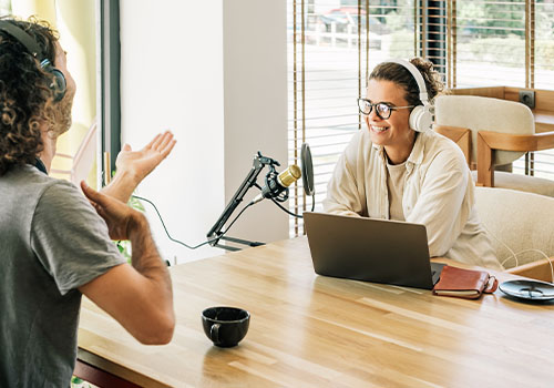 Two women recording a podcast