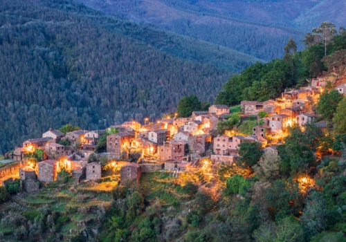 view of the mountains with schist houses at dusk.