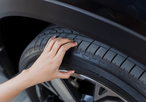Person checking tyre pressure