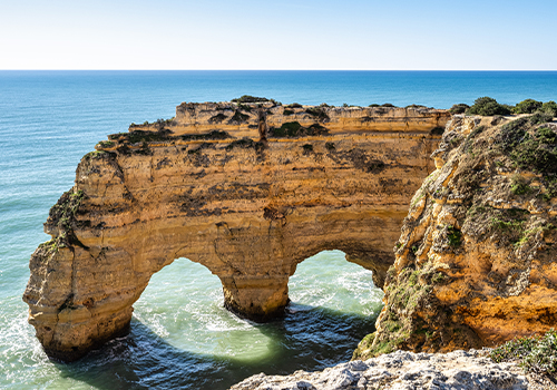 View of the most iconic cliff at Praia da Marinha, along the Seven Hanging Valleys Trail, Algarve, Portugal.