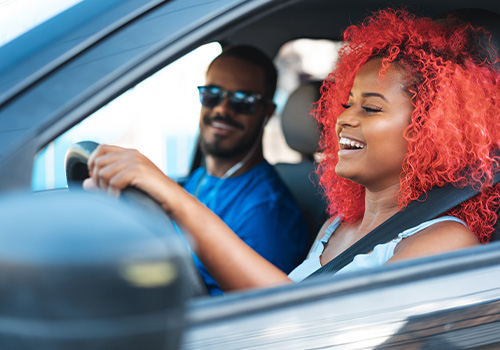 Gen Z couple driving a car